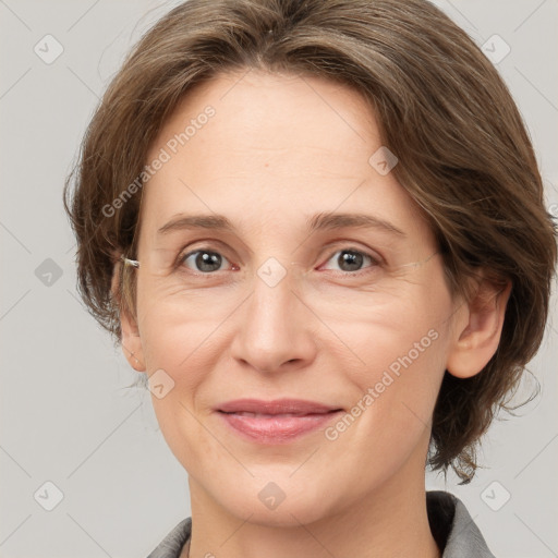 Joyful white adult female with medium  brown hair and grey eyes