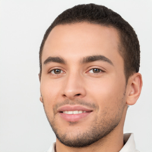 Joyful white young-adult male with short  black hair and brown eyes