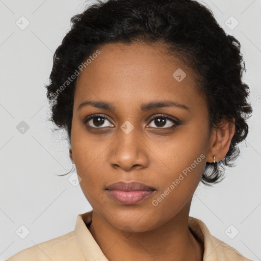 Joyful black young-adult female with long  black hair and brown eyes