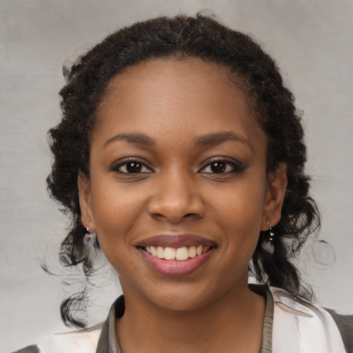Joyful black young-adult female with medium  brown hair and brown eyes