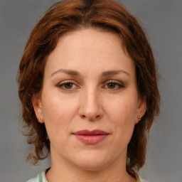 Joyful white adult female with medium  brown hair and brown eyes