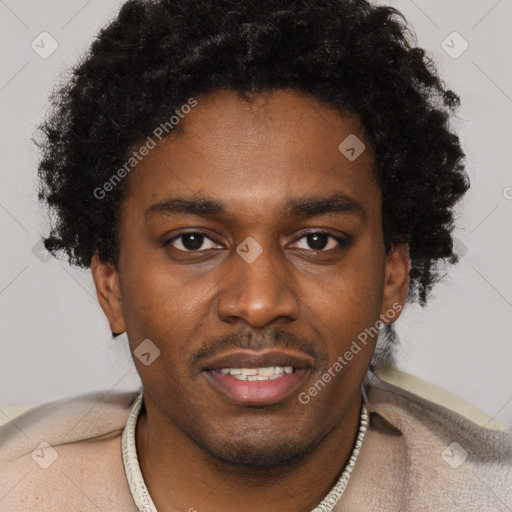 Joyful black young-adult male with short  brown hair and brown eyes