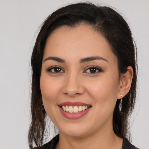 Joyful white young-adult female with long  brown hair and brown eyes