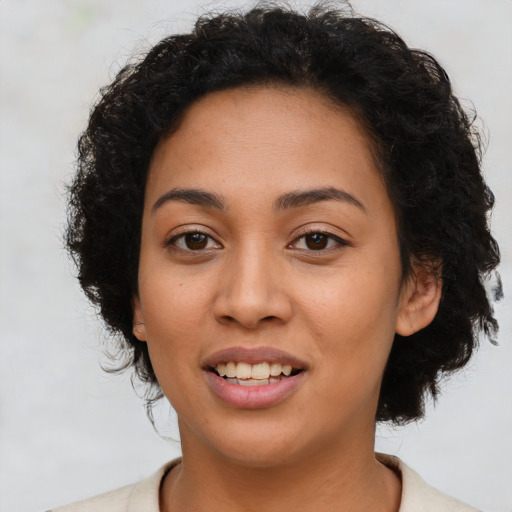 Joyful latino young-adult female with short  brown hair and brown eyes