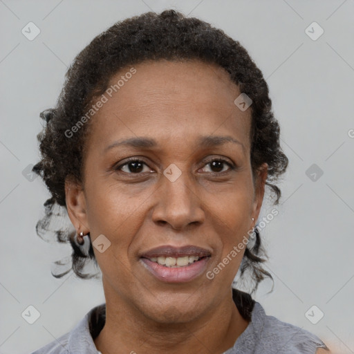 Joyful black adult female with short  brown hair and brown eyes