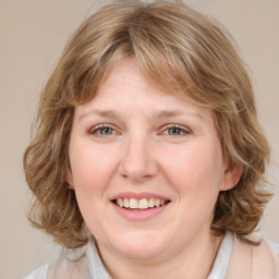 Joyful white young-adult female with medium  brown hair and blue eyes