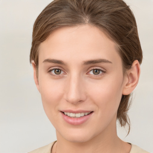 Joyful white young-adult female with short  brown hair and grey eyes