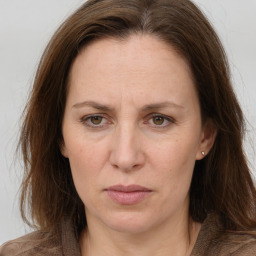 Joyful white adult female with long  brown hair and grey eyes