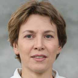 Joyful white adult female with short  brown hair and brown eyes