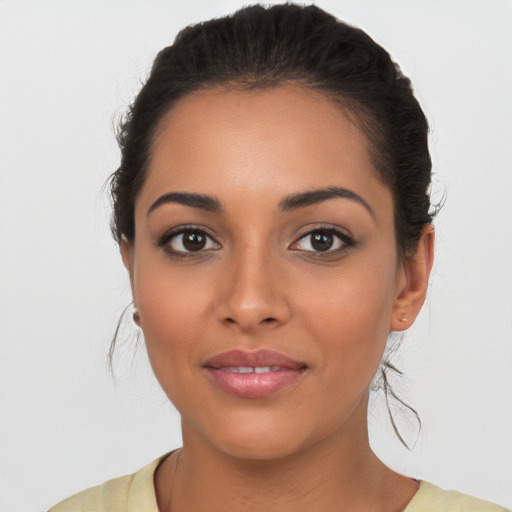 Joyful latino young-adult female with medium  brown hair and brown eyes