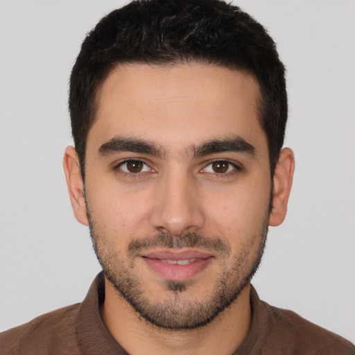 Joyful white young-adult male with short  black hair and brown eyes