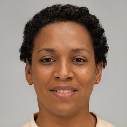 Joyful black young-adult female with short  brown hair and brown eyes
