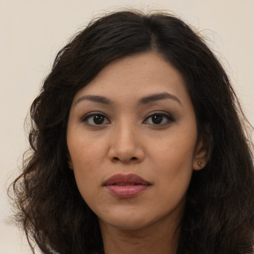 Joyful asian young-adult female with long  brown hair and brown eyes