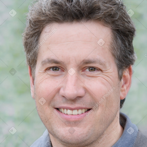 Joyful white adult male with short  brown hair and grey eyes