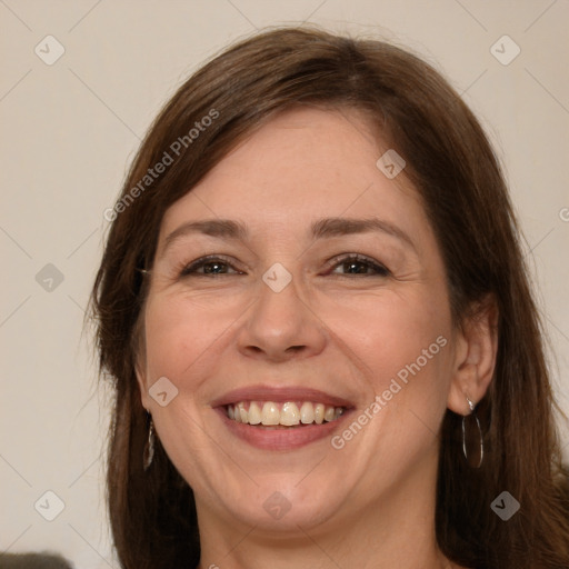 Joyful white adult female with long  brown hair and grey eyes