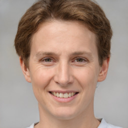 Joyful white adult female with short  brown hair and grey eyes