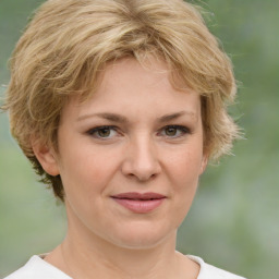 Joyful white young-adult female with medium  brown hair and green eyes