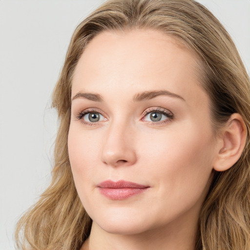 Joyful white young-adult female with long  brown hair and blue eyes