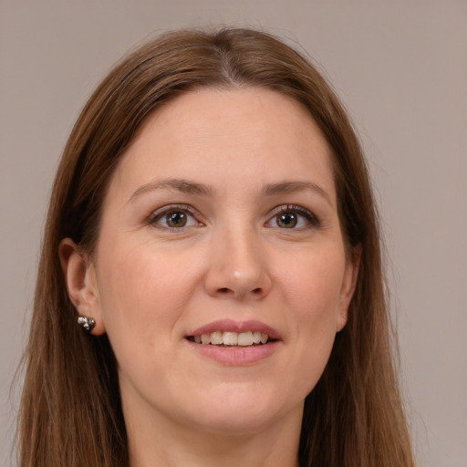 Joyful white adult female with long  brown hair and brown eyes