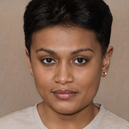 Joyful black young-adult female with short  black hair and brown eyes