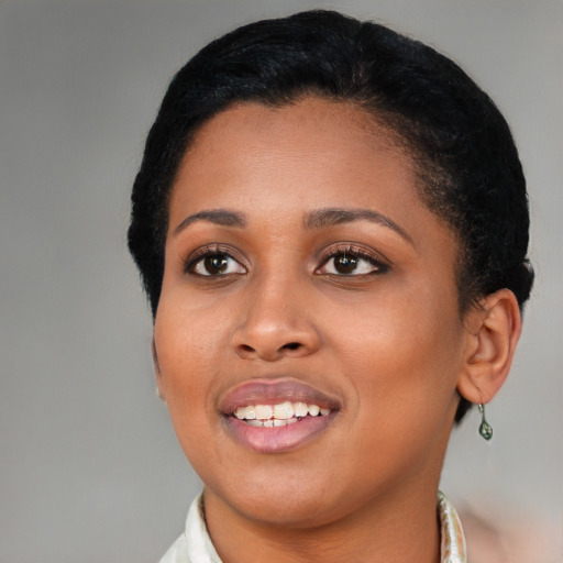 Joyful black young-adult female with medium  black hair and brown eyes