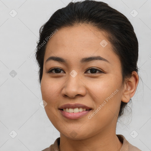 Joyful latino young-adult female with medium  brown hair and brown eyes