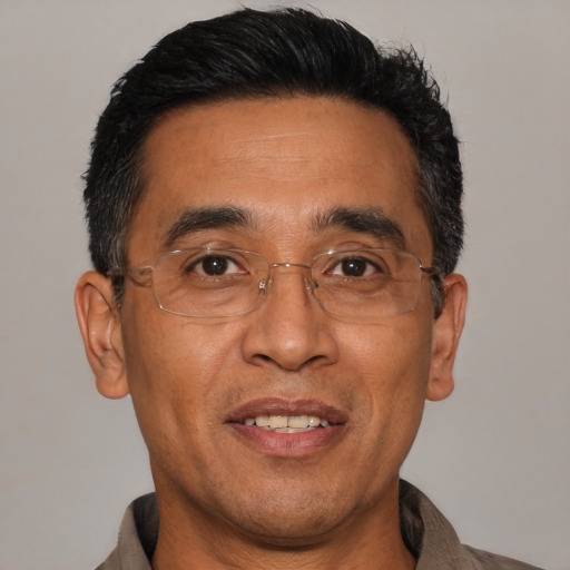Joyful asian adult male with short  black hair and brown eyes