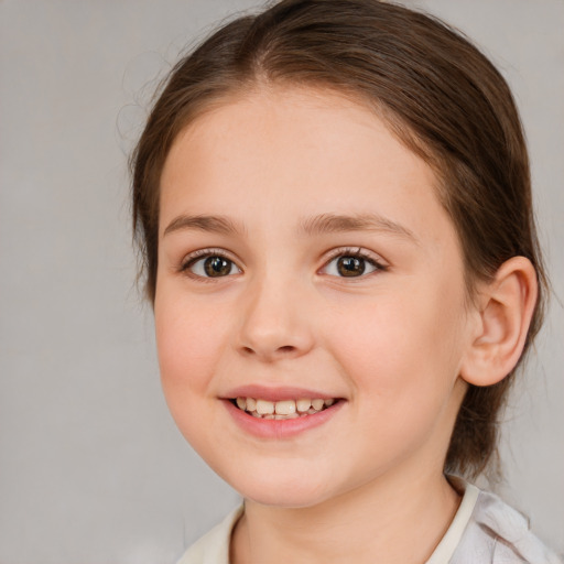 Joyful white child female with medium  brown hair and brown eyes