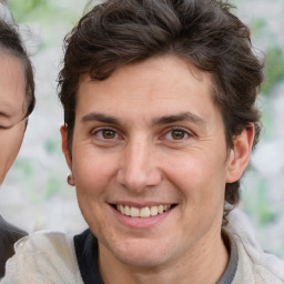 Joyful white adult male with medium  brown hair and brown eyes