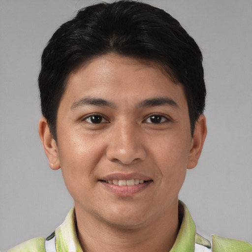 Joyful latino young-adult male with short  brown hair and brown eyes