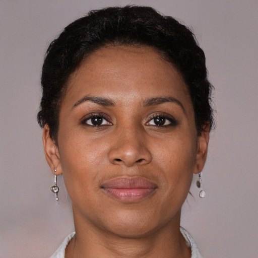 Joyful black young-adult female with short  brown hair and brown eyes