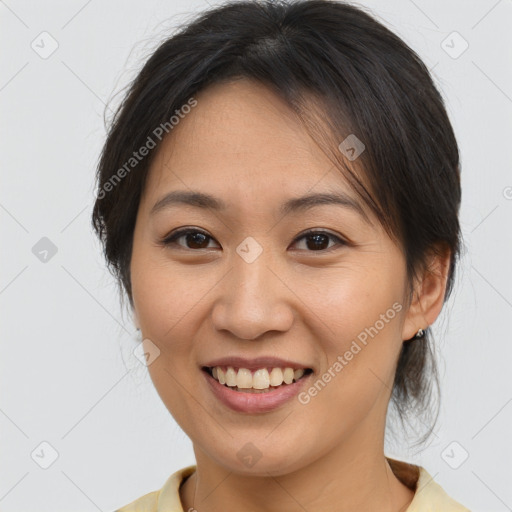 Joyful asian young-adult female with medium  brown hair and brown eyes