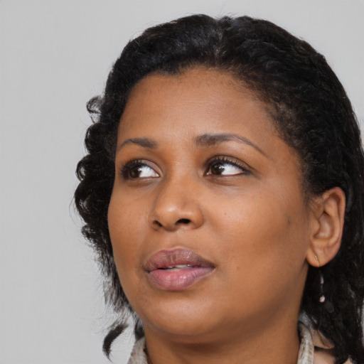Joyful black young-adult female with medium  black hair and brown eyes