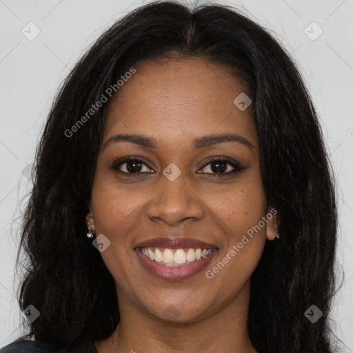 Joyful black young-adult female with long  brown hair and brown eyes