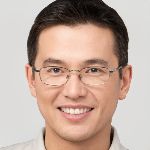 Joyful white adult male with short  brown hair and brown eyes