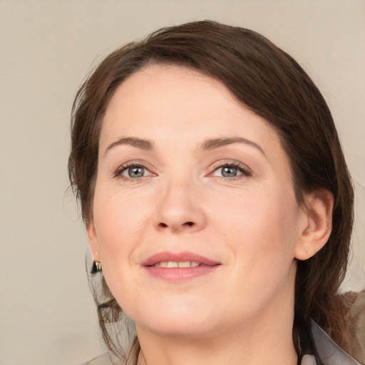 Joyful white adult female with medium  brown hair and brown eyes