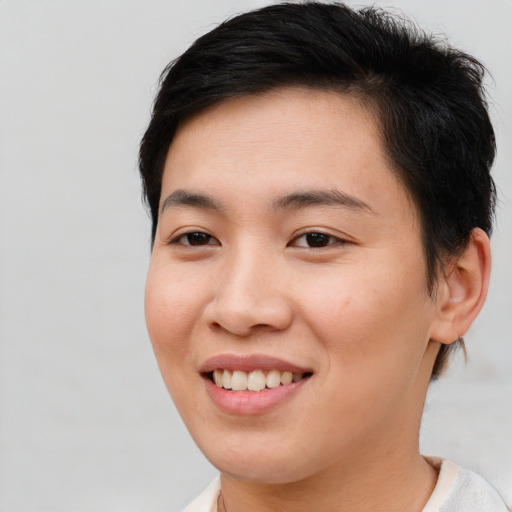 Joyful asian young-adult female with short  brown hair and brown eyes