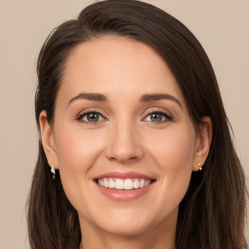 Joyful white young-adult female with long  brown hair and brown eyes