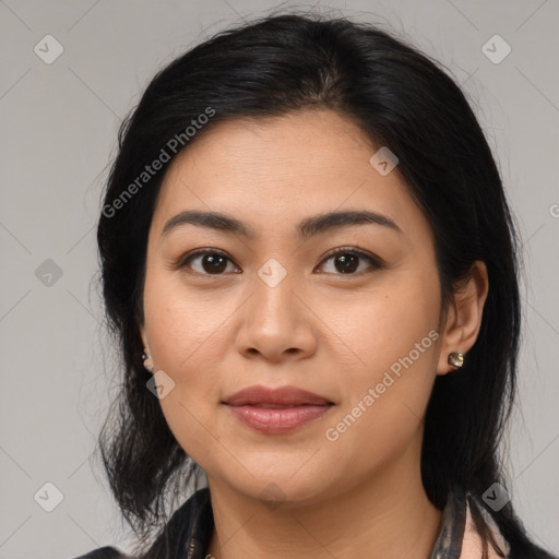 Joyful latino young-adult female with medium  brown hair and brown eyes