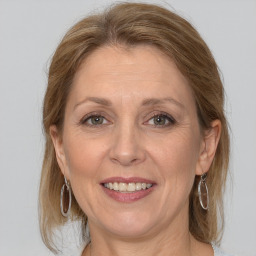 Joyful white adult female with medium  brown hair and grey eyes