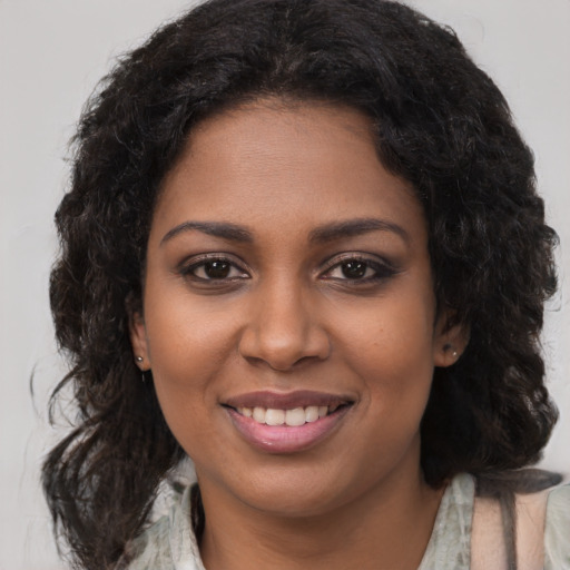 Joyful black young-adult female with medium  brown hair and brown eyes