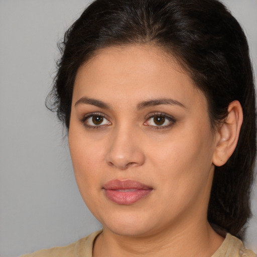 Joyful latino young-adult female with medium  brown hair and brown eyes