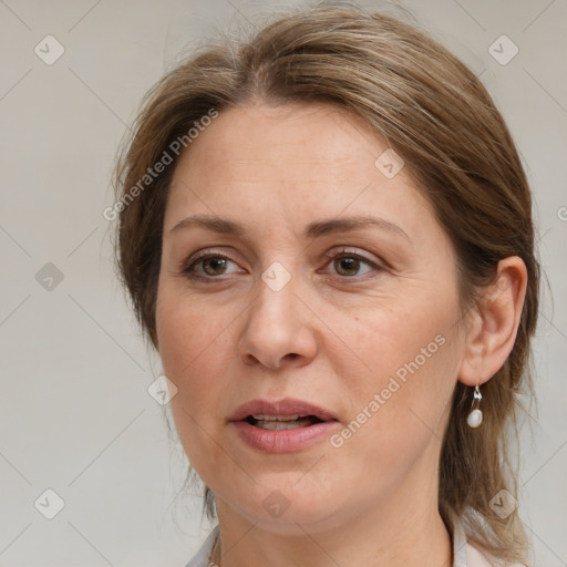 Joyful white adult female with medium  brown hair and grey eyes