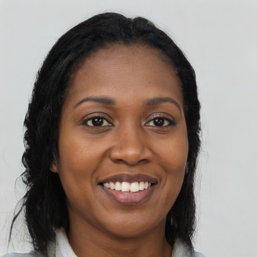 Joyful black young-adult female with medium  black hair and brown eyes