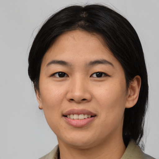 Joyful asian young-adult female with medium  brown hair and brown eyes