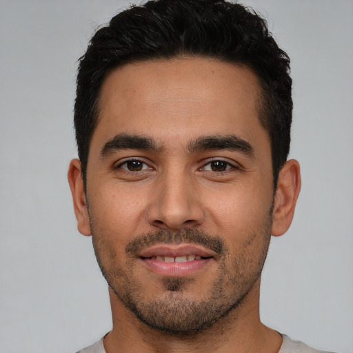 Joyful white young-adult male with short  black hair and brown eyes