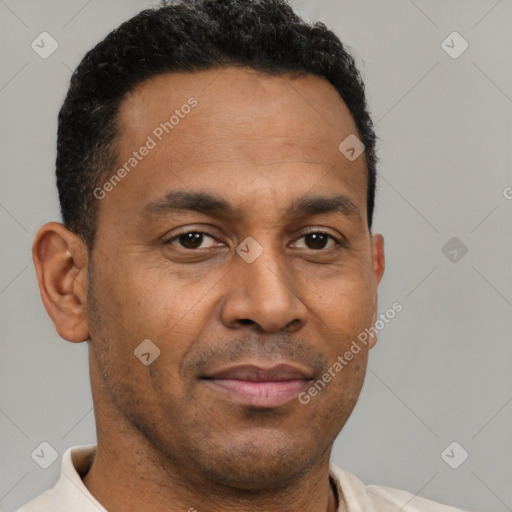 Joyful latino young-adult male with short  brown hair and brown eyes