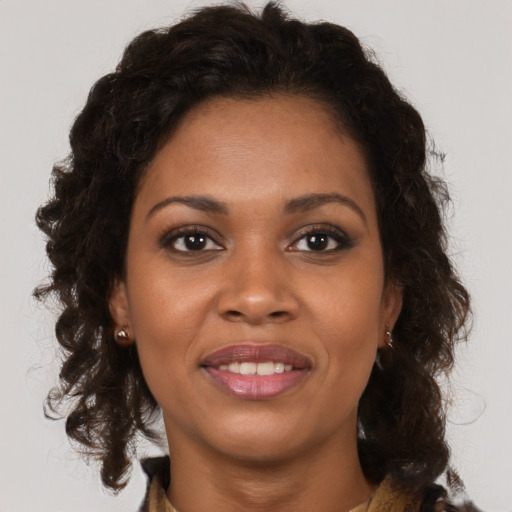 Joyful black young-adult female with medium  brown hair and brown eyes