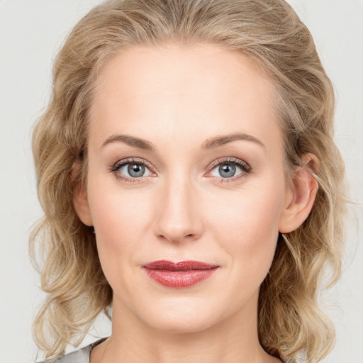 Joyful white young-adult female with medium  brown hair and blue eyes