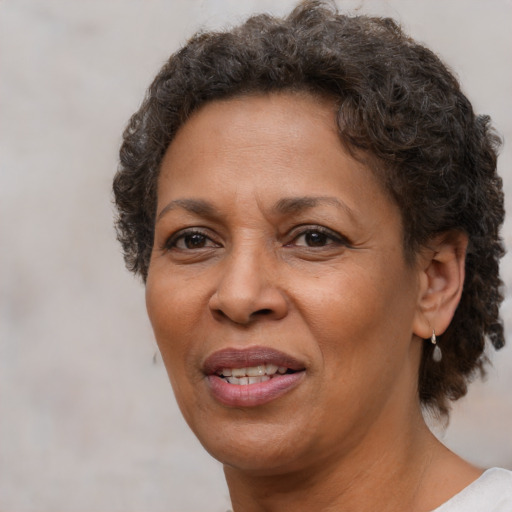 Joyful black adult female with short  brown hair and brown eyes